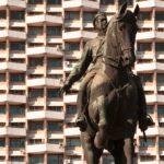 Monument to Grigory Kotovsky (installed in 1954) in front of the "Cosmos" hotel. He was Russian revolutionary, Soviet military and political leader, hero of the Civil War., black horse statue near white building during daytime
