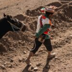 , a boy running with a horse